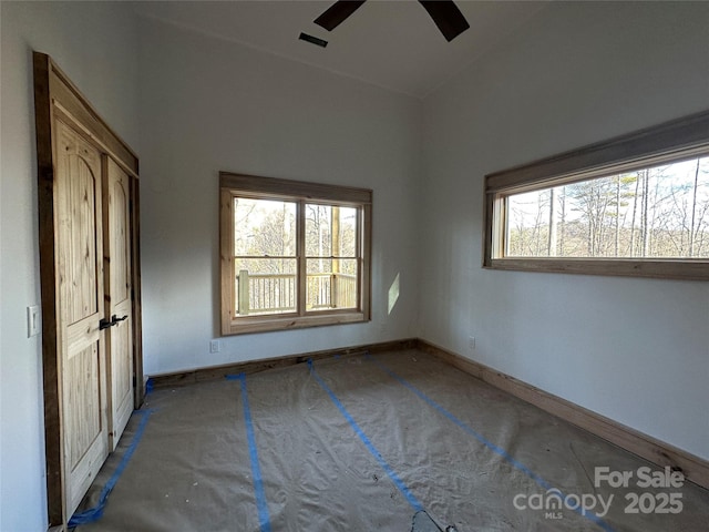 unfurnished bedroom with ceiling fan, visible vents, and baseboards