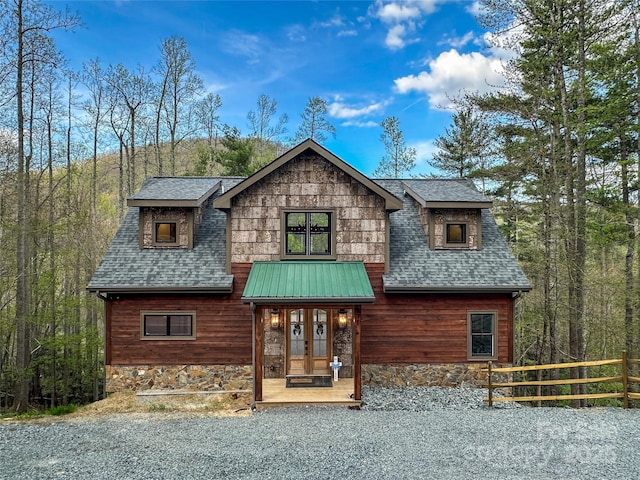 371 Hews Cir, Blowing Rock, NC 28605 - view of front facade featuring roof with shingles, fence, and stone siding