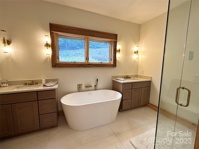 371 Hews Cir, Blowing Rock, NC 28605 - bathroom featuring a shower stall, two vanities, tile patterned floors, a freestanding bath, and baseboards
