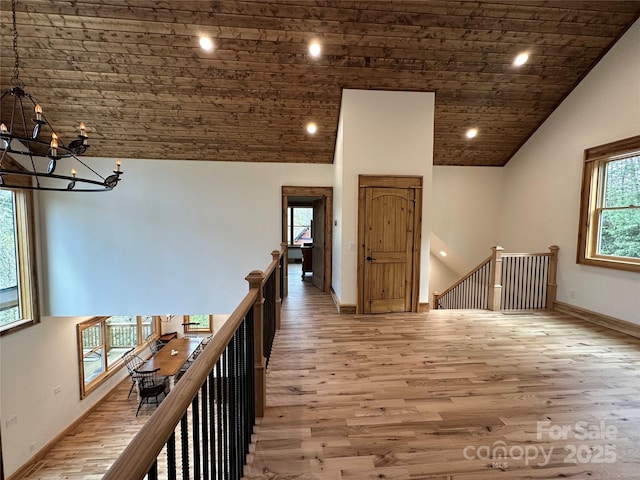 371 Hews Cir, Blowing Rock, NC 28605 - hallway featuring an upstairs landing, a chandelier, light wood-style floors, wood ceiling, and recessed lighting