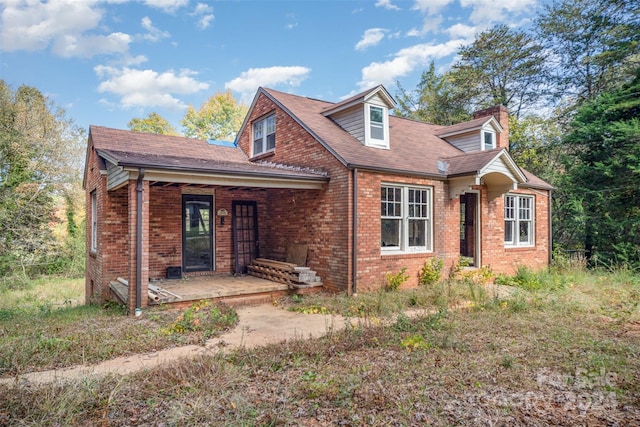 cape cod-style house with a patio