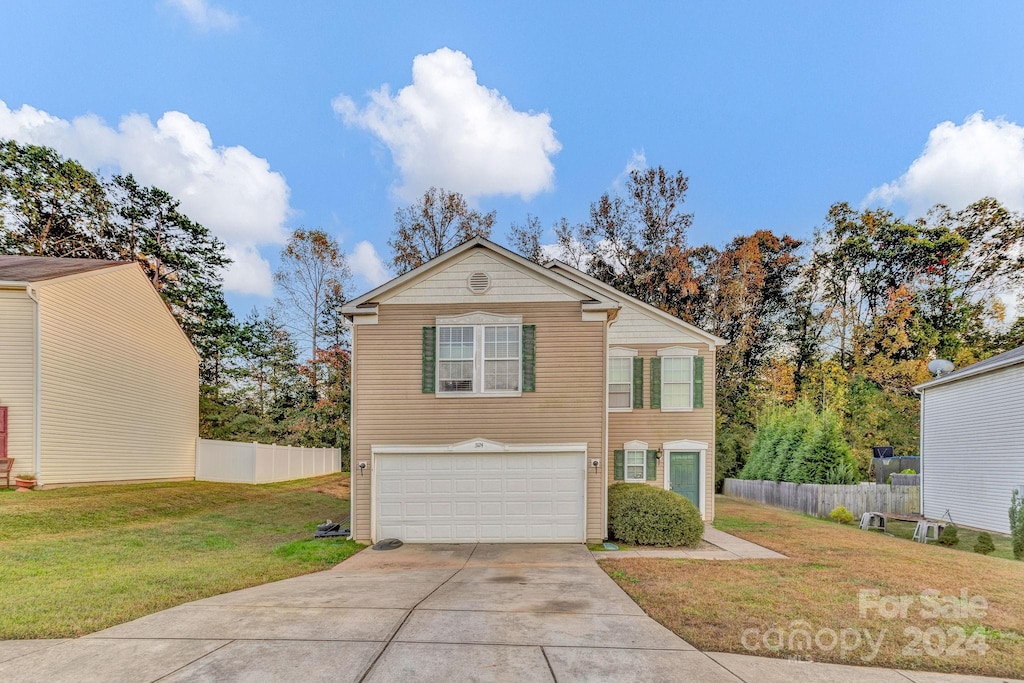 view of front of house featuring a front yard and a garage