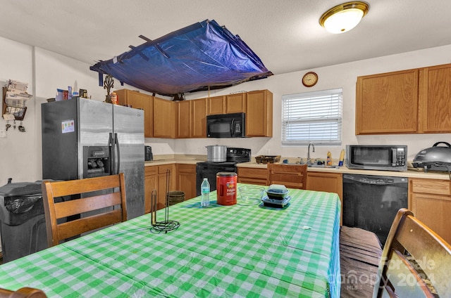 kitchen featuring black appliances and sink