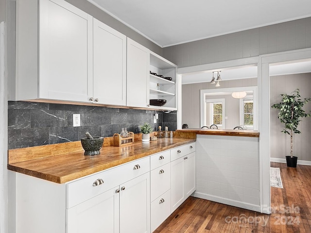 kitchen featuring white cabinets, butcher block countertops, and dark hardwood / wood-style floors