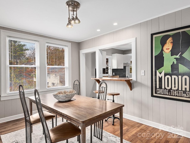 60 Fulton St, Asheville, NC 28801 - dining room featuring wood finished floors, baseboards, crown molding, a decorative wall, and recessed lighting