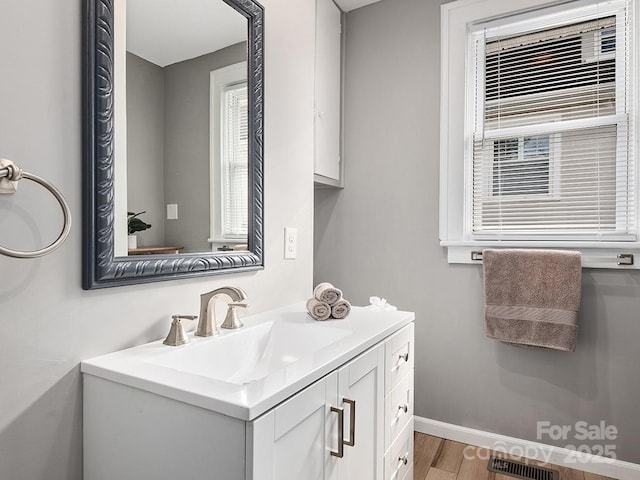 60 Fulton St, Asheville, NC 28801 - bathroom with wood finished floors, vanity, and baseboards