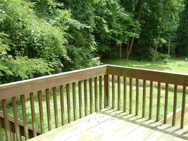 wooden deck featuring a yard