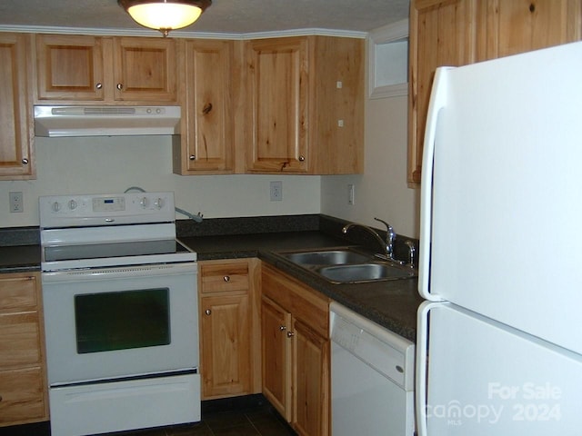 kitchen featuring sink, dark tile patterned flooring, and white appliances