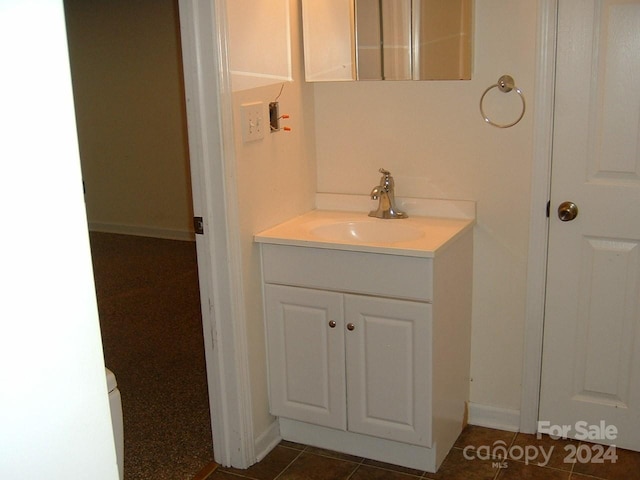 bathroom featuring tile patterned flooring and vanity