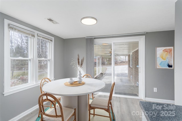 dining space with light hardwood / wood-style floors