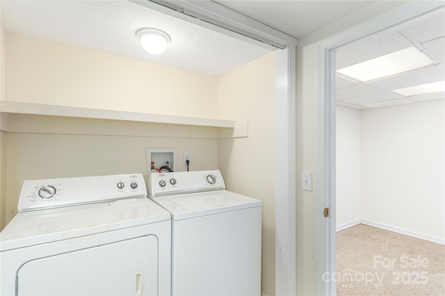 clothes washing area with washing machine and dryer and light carpet