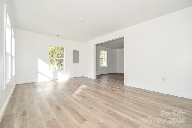 spare room featuring light hardwood / wood-style flooring and electric panel