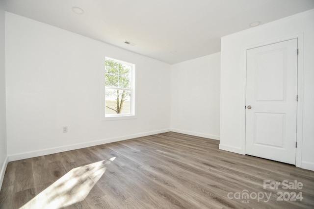 spare room featuring hardwood / wood-style floors