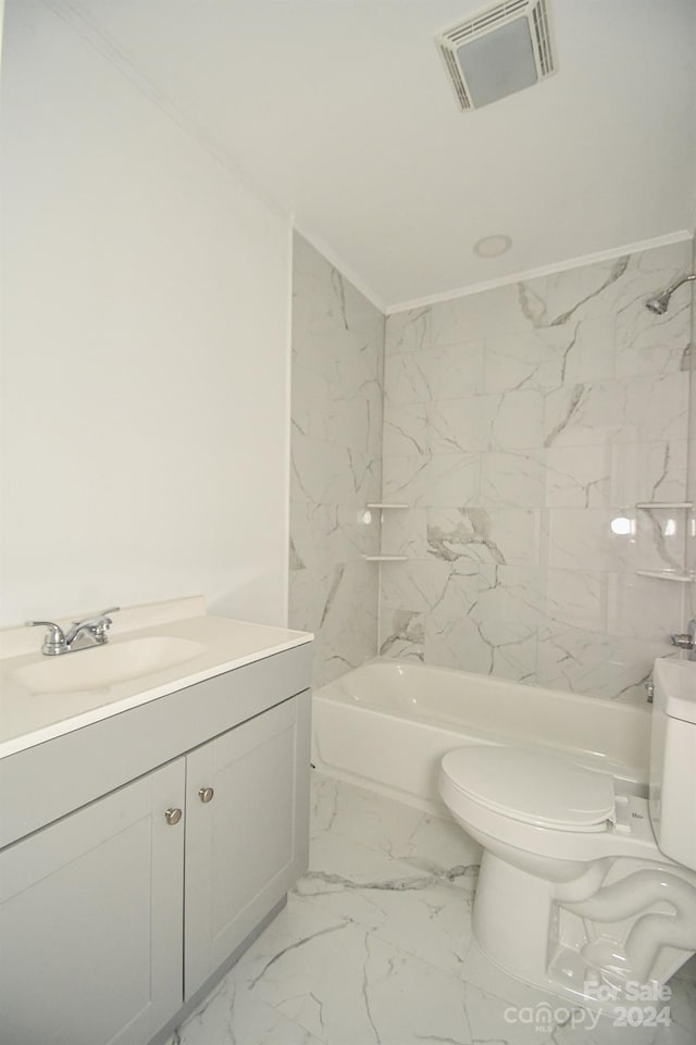 full bathroom with vanity, toilet, crown molding, and tiled shower / bath