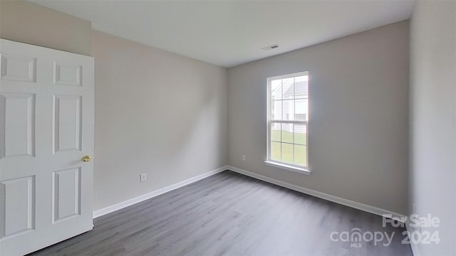 empty room with wood-type flooring