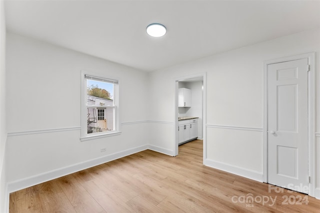 unfurnished room with light hardwood / wood-style flooring