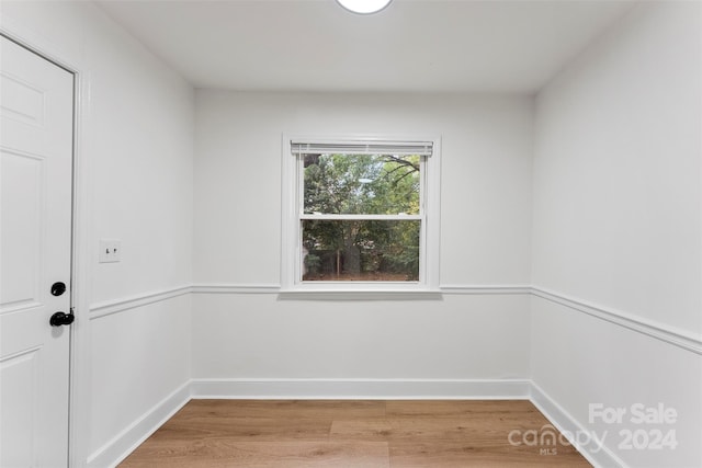 spare room featuring wood-type flooring