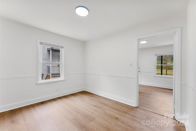 unfurnished room with light wood-type flooring