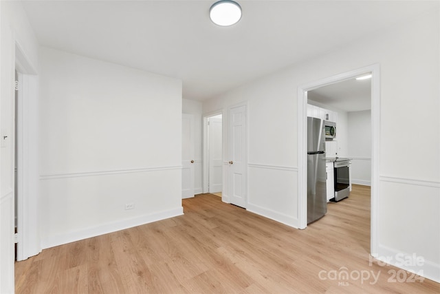 spare room featuring light hardwood / wood-style flooring