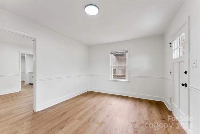 empty room with light hardwood / wood-style flooring