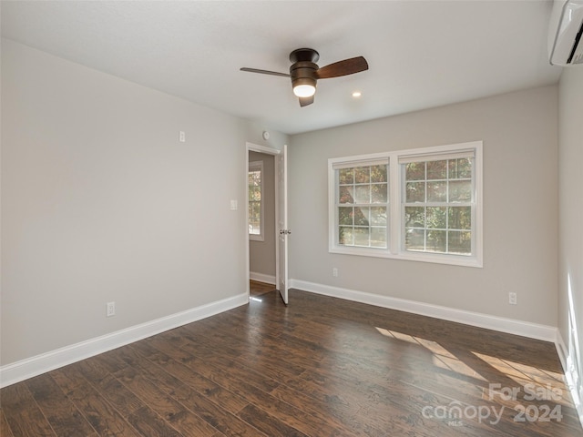 unfurnished room featuring ceiling fan, dark hardwood / wood-style flooring, and a wall mounted air conditioner