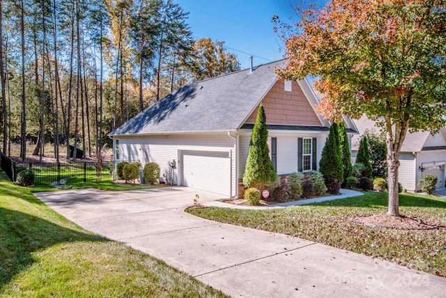 view of front of home with a front yard and a garage