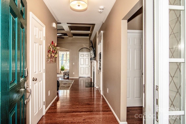 interior space featuring ornamental molding, dark hardwood / wood-style floors, beamed ceiling, and coffered ceiling