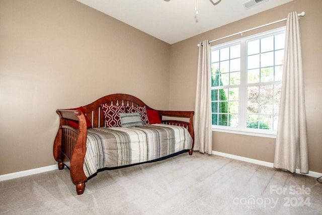 bedroom featuring vaulted ceiling, carpet, and multiple windows