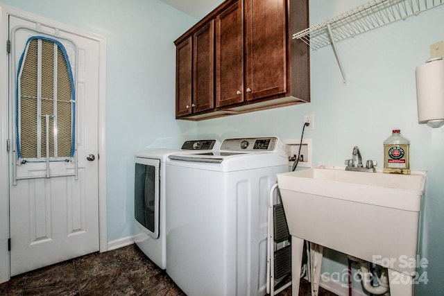 laundry area featuring sink, cabinets, and separate washer and dryer