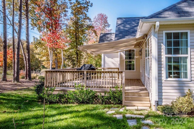 wooden deck with a lawn