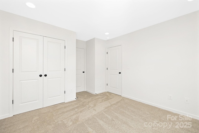 unfurnished bedroom with light colored carpet