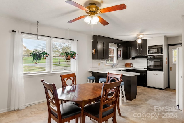 dining area featuring ceiling fan, a textured ceiling, and sink