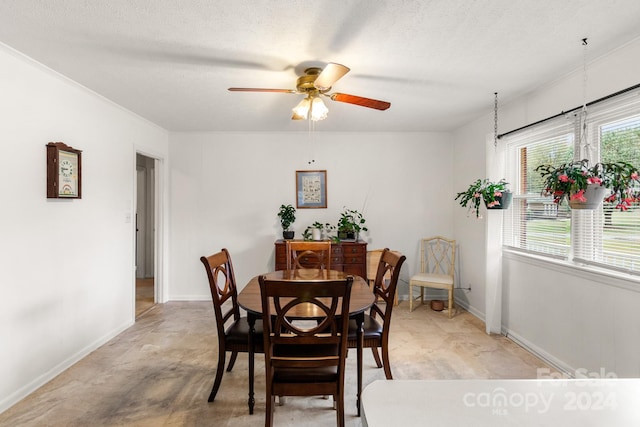 dining room featuring a textured ceiling, ceiling fan, and crown molding