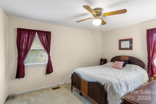 bedroom with light carpet and ceiling fan