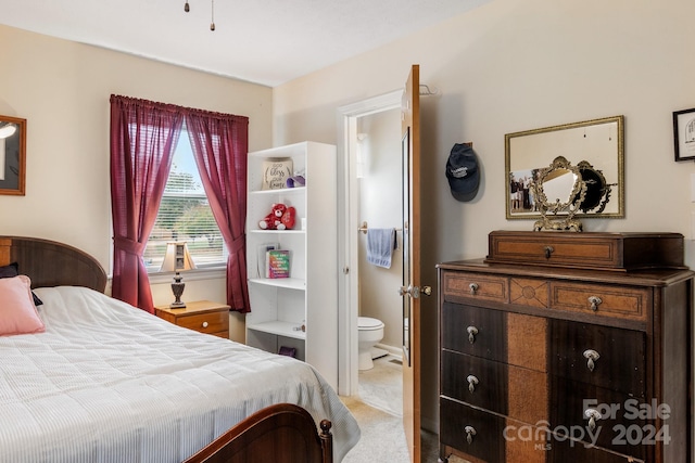 bedroom with carpet floors and connected bathroom