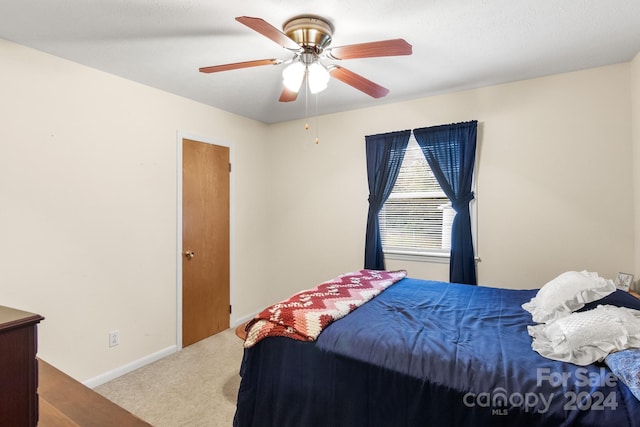 carpeted bedroom featuring ceiling fan