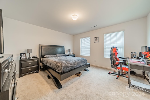 bedroom featuring light carpet