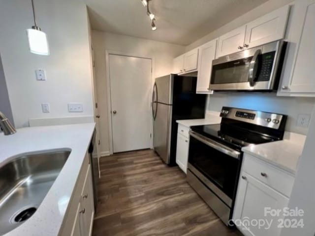 kitchen with sink, white cabinetry, stainless steel appliances, and dark hardwood / wood-style floors