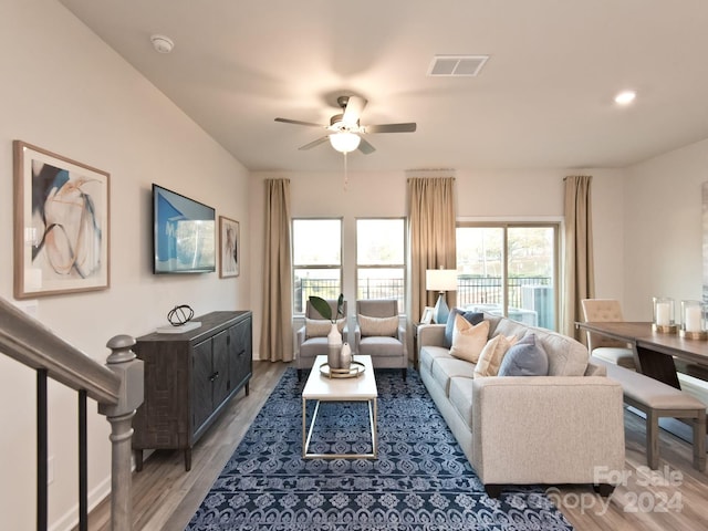 living room with ceiling fan and light hardwood / wood-style flooring