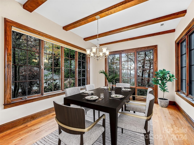 dining area featuring wood-type flooring, beamed ceiling, and a chandelier