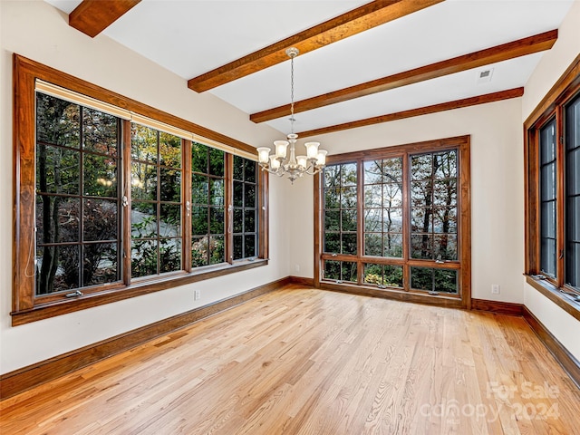 unfurnished sunroom featuring a chandelier and beam ceiling