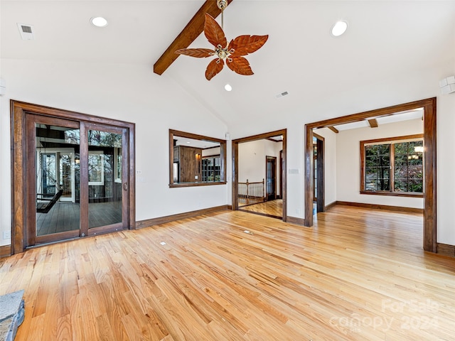 unfurnished living room with lofted ceiling with beams, light hardwood / wood-style floors, and ceiling fan