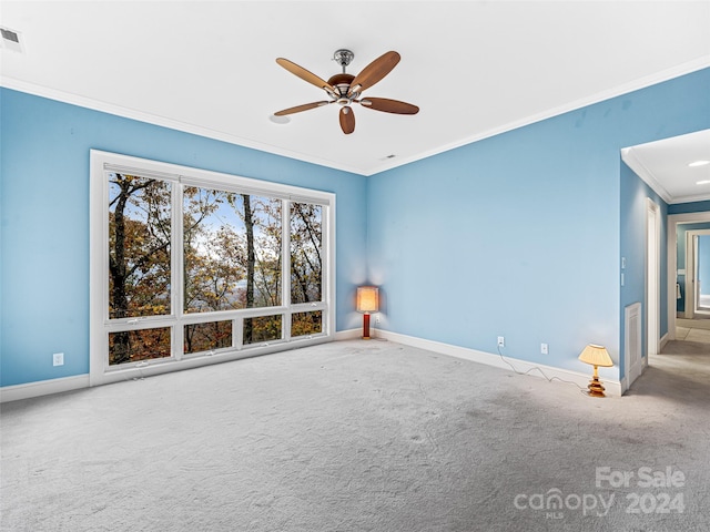 unfurnished room featuring carpet, ceiling fan, and crown molding