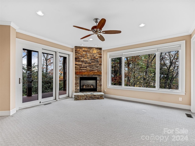 unfurnished living room with a wealth of natural light, ceiling fan, crown molding, and carpet floors