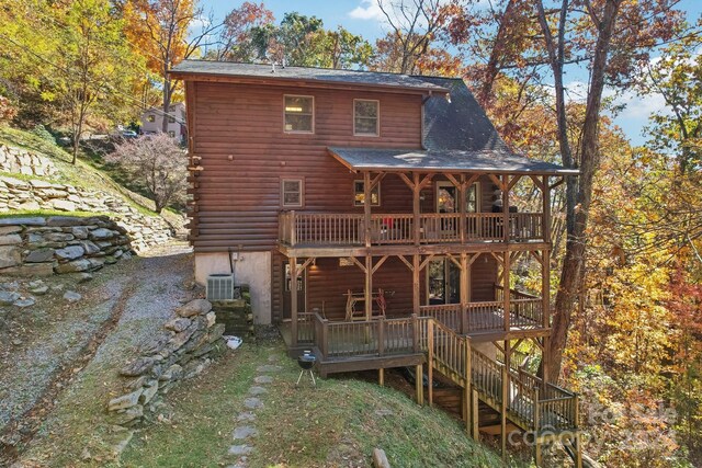 rear view of property with a wooden deck