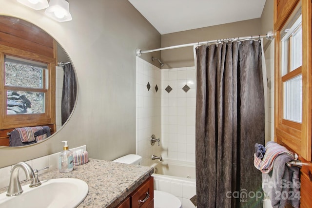 full bathroom featuring vanity, shower / tub combo with curtain, and toilet