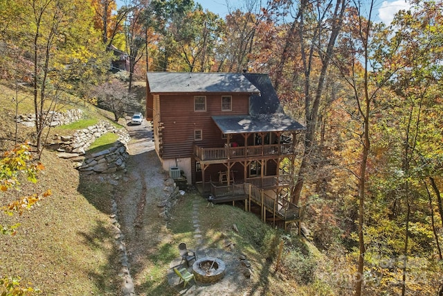 back of property featuring a wooden deck and cooling unit