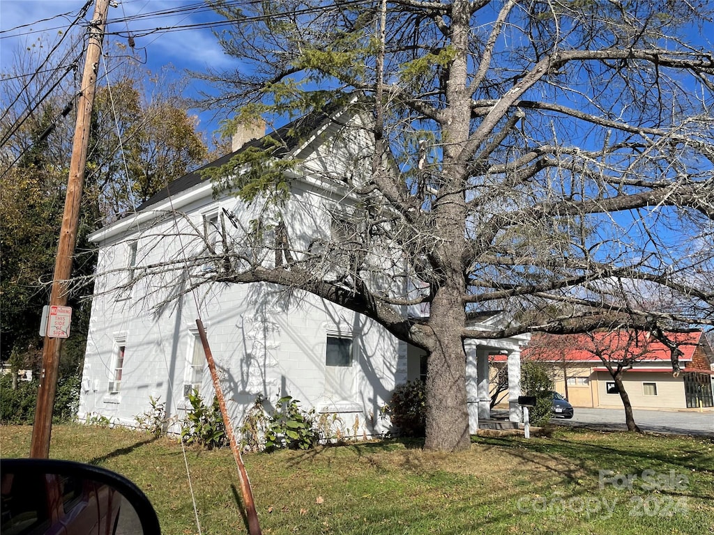 view of side of property with a yard