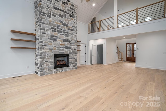 6630 Vesuvius Furnace Rd Unit 1, Denver, NC 28037 - unfurnished living room with a fireplace, baseboards, french doors, and wood finished floors