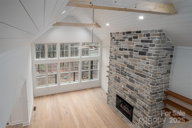 6630 Vesuvius Furnace Rd Unit 1, Denver, NC 28037 - living room featuring baseboards, light wood finished floors, high vaulted ceiling, a stone fireplace, and beamed ceiling